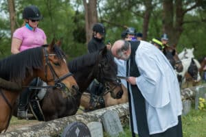 Horseman's Sunday event. Vicar blesses the horses at St Martha's Church