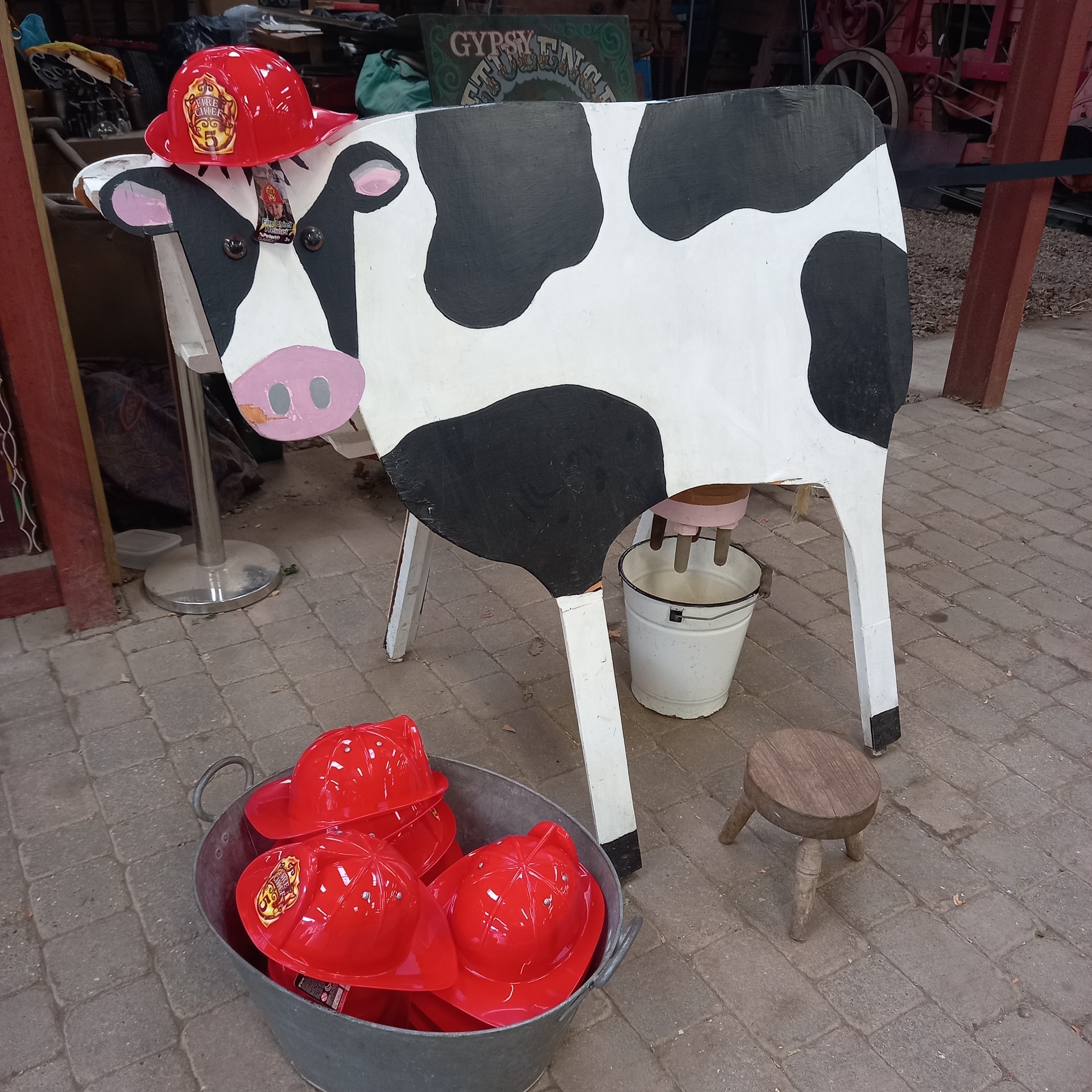 Wooden milking cow as fun interactive exhibit at museum