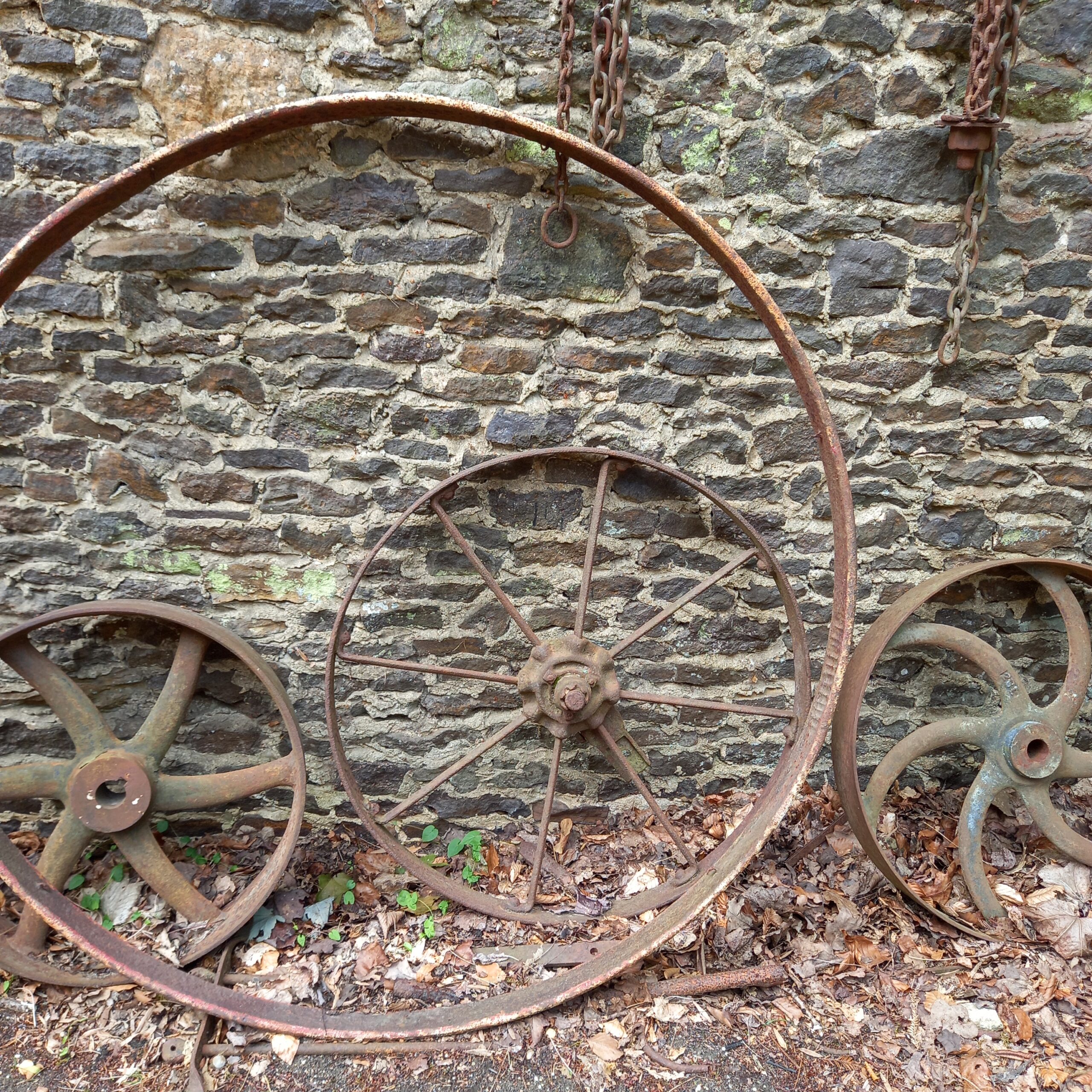 Iron wheels against a wall.