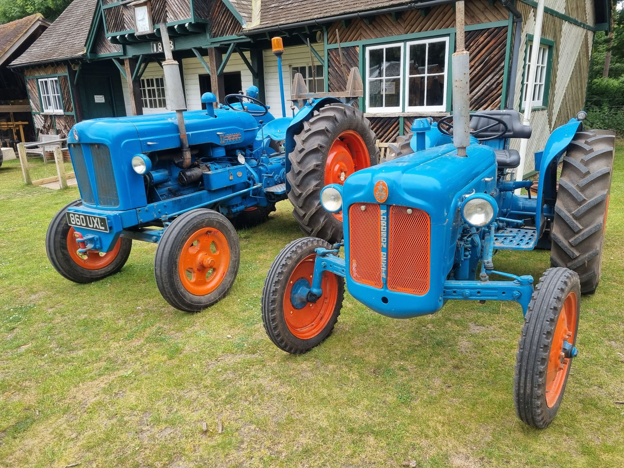 Blue tractors on lawn at museum