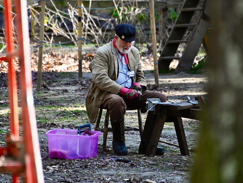 Man in traditional clothing sitting on a chair at the Surrey Hills Spring Fair