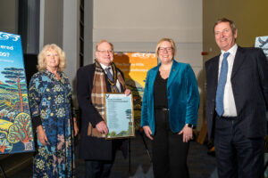 Artist Diana Croft infront of her artwork with Surrey County Council Chairman Tim Hall, MP Zoe Franklin and Michael More-Molyneux Lord Lieutenant of Surrey
